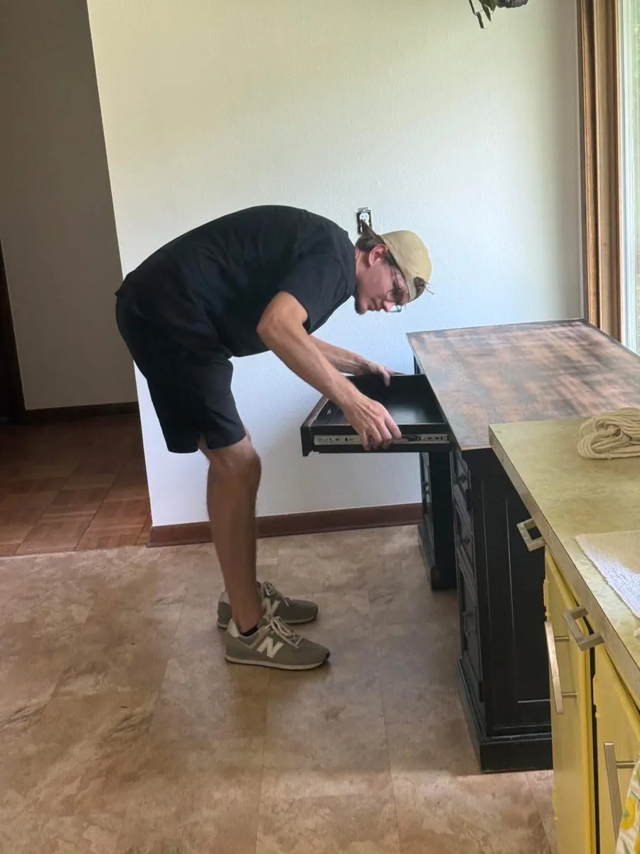Red Dirt mover carefully disassembling furniture during a packing job
