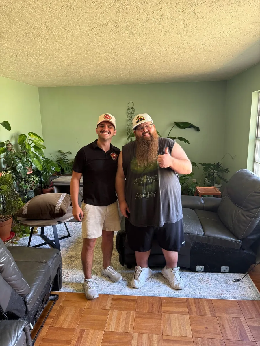 Red Dirt Moving Co. owner with a customer in their new living room